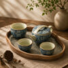 Handcrafted artisan spiritual products on a wooden surface with incense and tea set