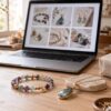Artisan gemstone jewelry online displayed beside a laptop in a calm maker studio
