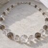 Crystal necklace of clear quartz and smoky crystal beads in natural daylight
