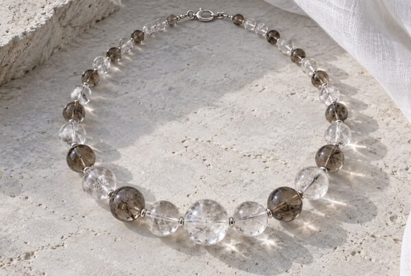 Crystal necklace of clear quartz and smoky crystal beads in natural daylight