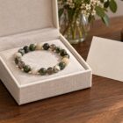 Meaningful gemstone bracelet gift in an ivory linen jewelry box with a blank note